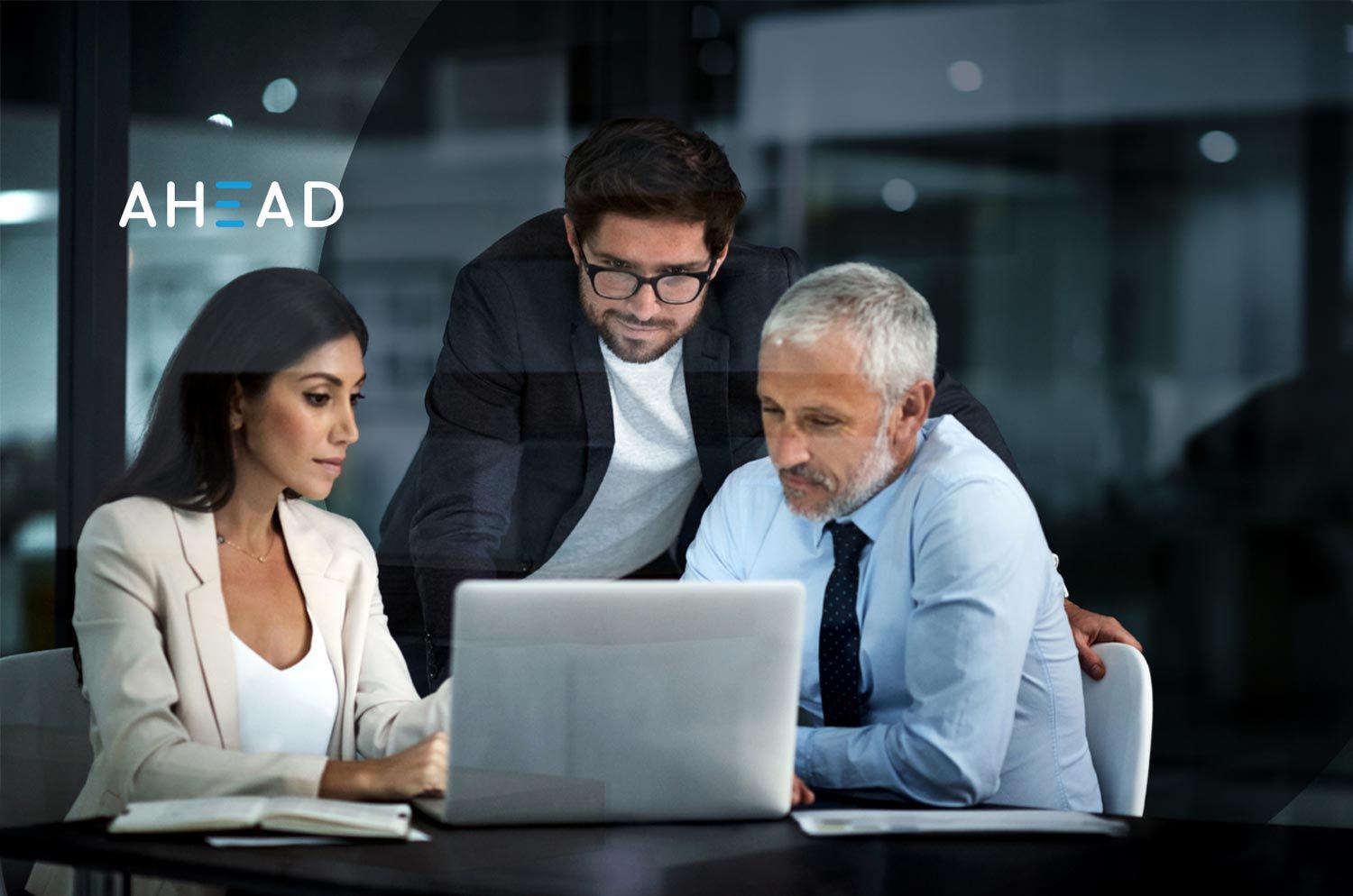 3 people looking at a laptop